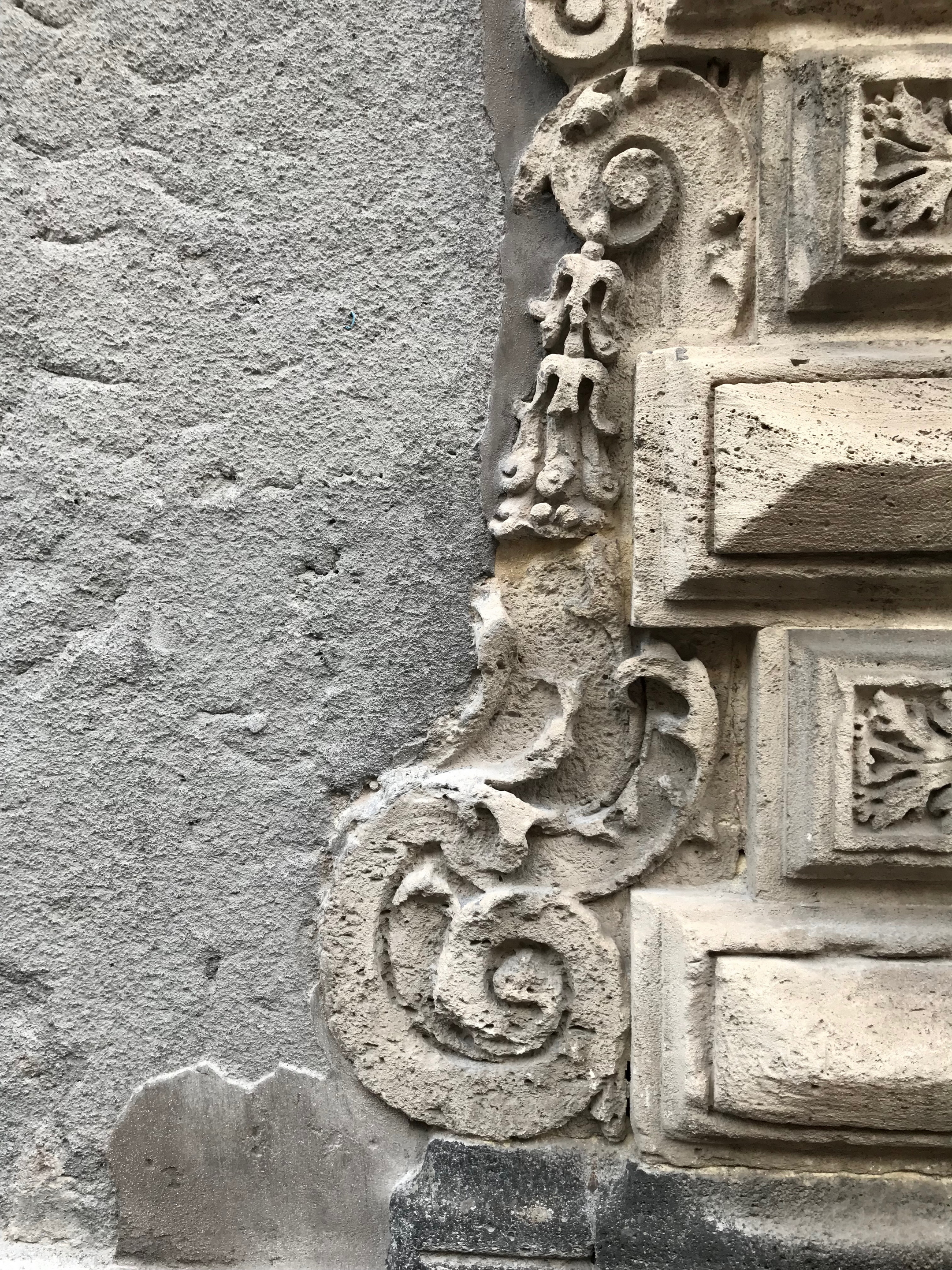 Biscari Palace in Catania, detail of the facede made with a black pepper colour shade clay plaster