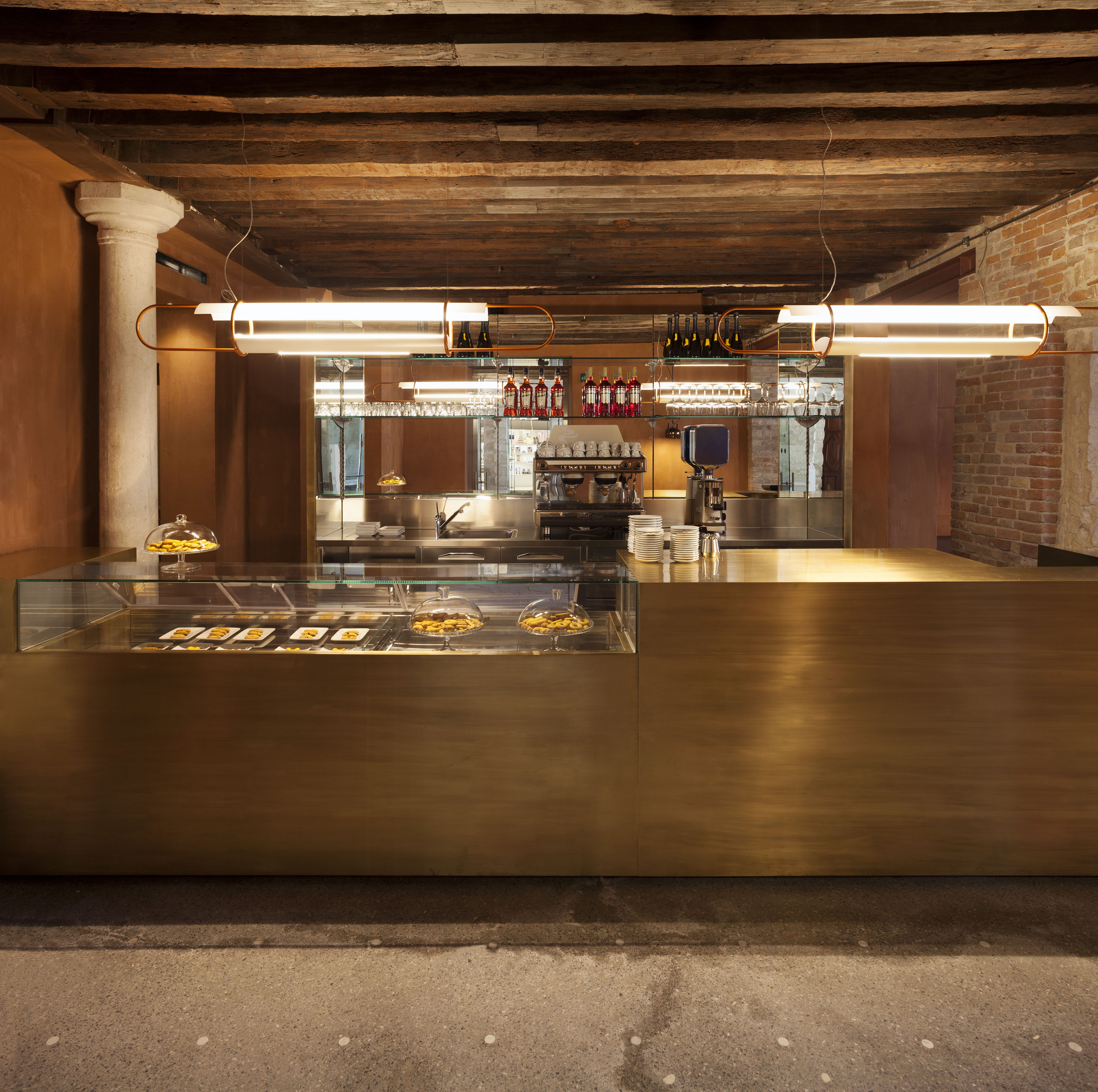Fine-grained mixture of clays and mineral binders TerraTon Plus Wall bespoke Wabi Melograno (pomegranade) color by Matteo Brioni applied to vertical surfaces in the Cafeteria of the Ca' Pesaro palace in Venice. Project by Baldessari & Baldessari, photo by Paolo Riolzi
