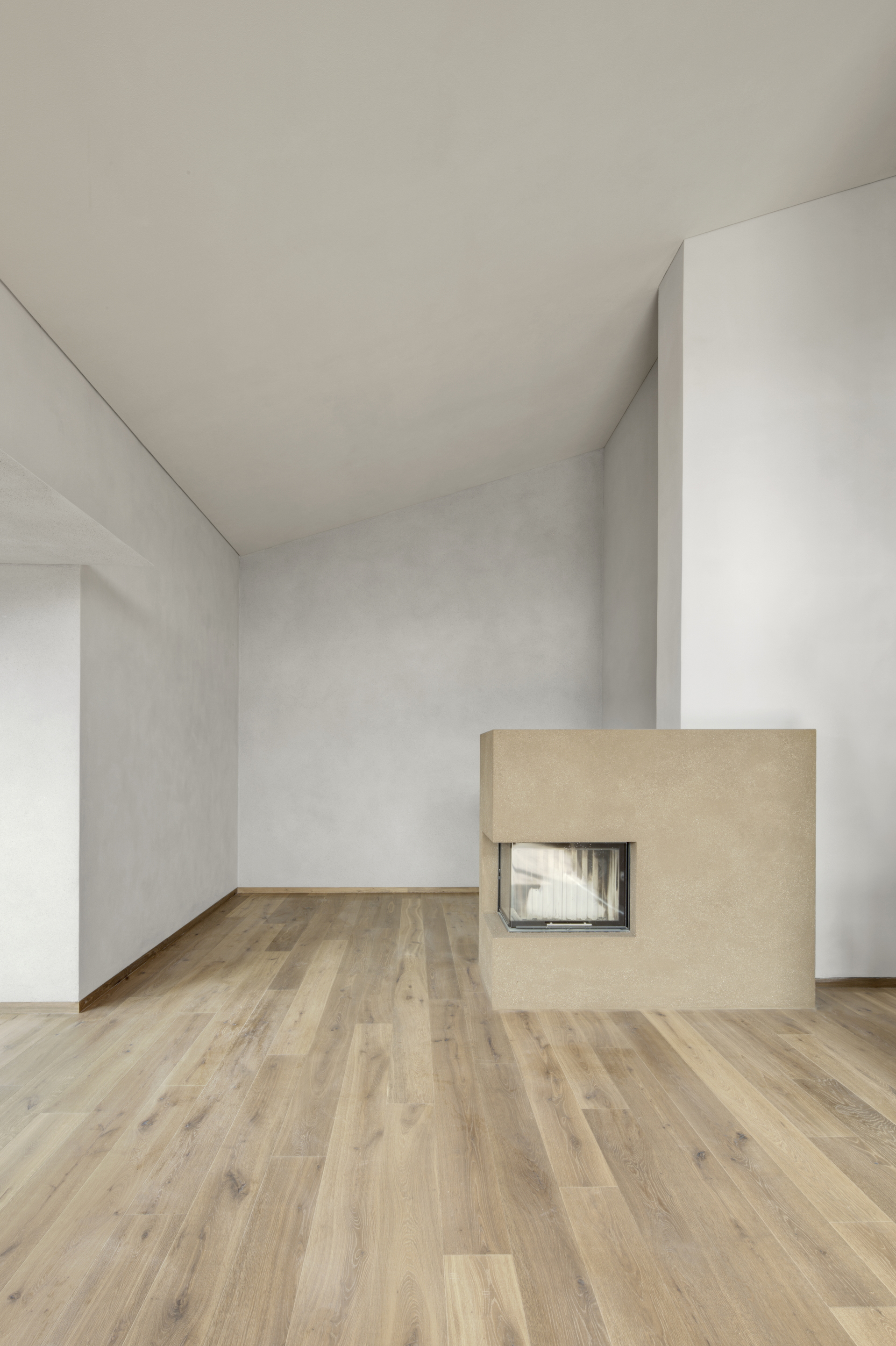 Matteo Brioni's coarse-grained clay plaster MultiTerra Smooth Cacao and Panna colors installed on walls, ceilings and furnitures in a private house in Brunico by Pedevilla Architects
