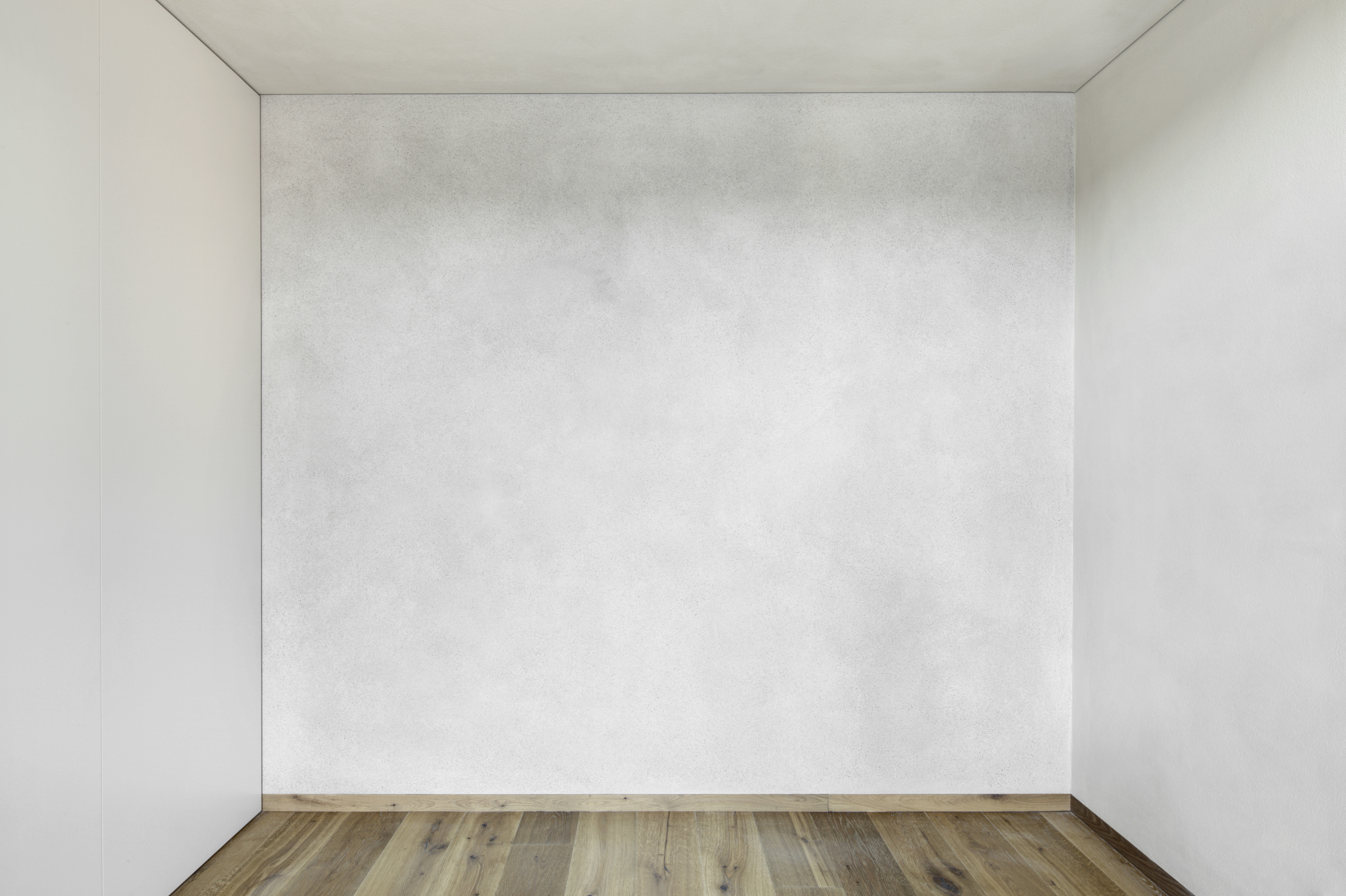 Matteo Brioni's coarse-grained clay plaster MultiTerra Smooth Panna (cream) color installed on walls, ceilings and furnitures in a private house in Brunico by Pedevilla Architects