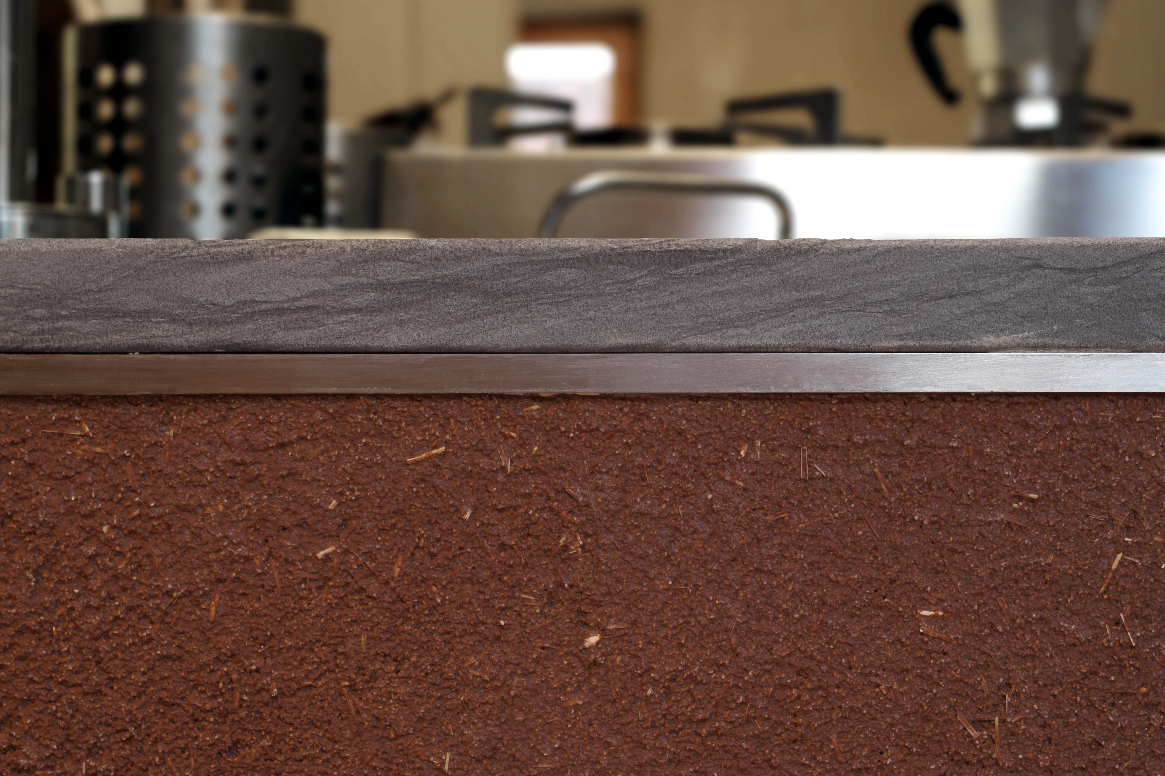 Matteo Brioni's coarse-grained clay plaster MultiTerra Structured Melograno (pomegranade) color with straw as added aggregate in a private house in Milan by Ciro Massaro