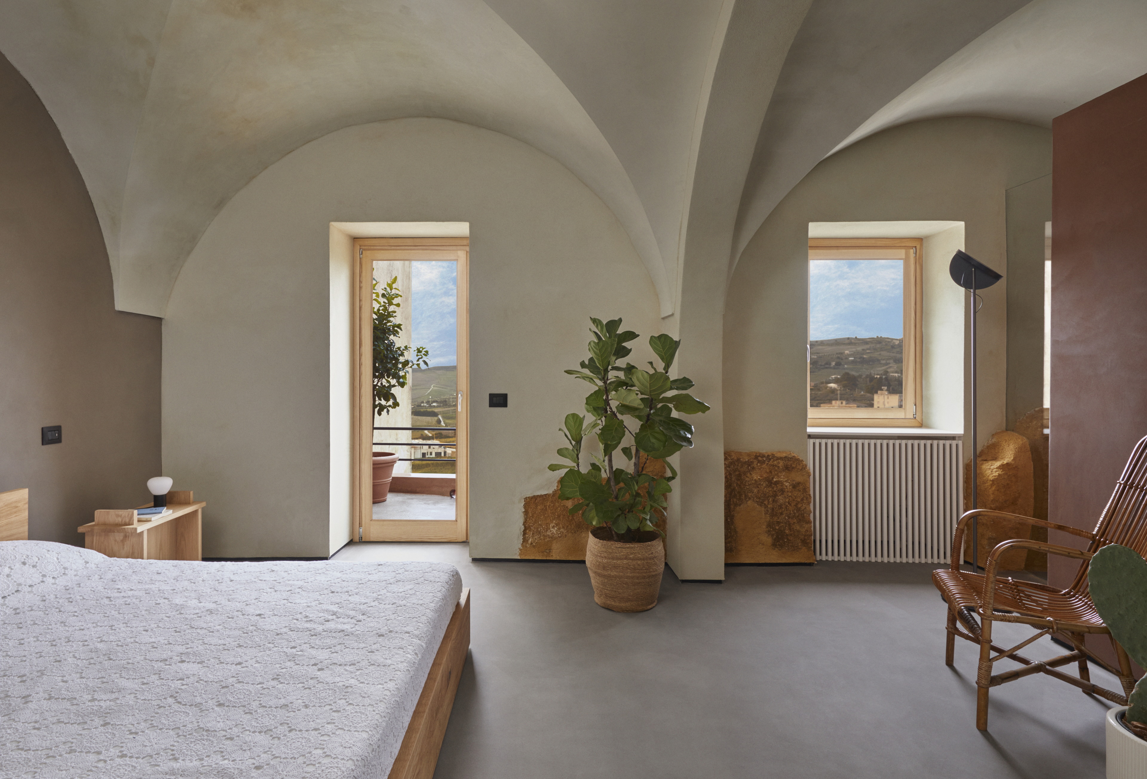 Matteo Brioni's mineral coating TerraFloor Smooth Sale Grigio (gray salt) color on floors, fine-grained clay plaster TerraVista Smooth Sale Grigio (gray salt) and Cammeo (cameo) colors with Plus customization on walls for Airbnb 1 Euro House in Sambuca di