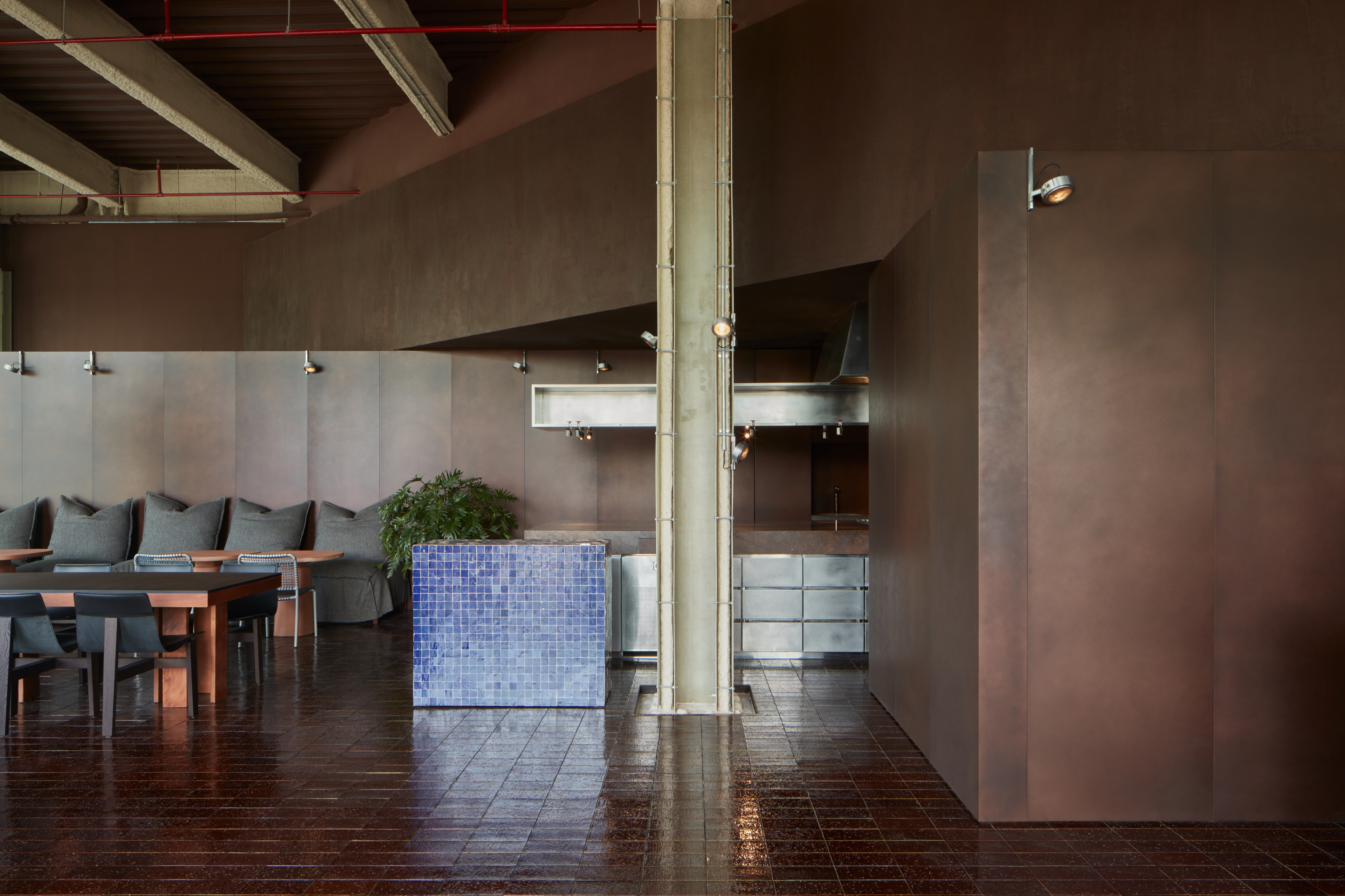 Clay and lime tadelakt finishing plaster TerraCalix Smooth custom color (Deep Maroon) for Terra Al Qana restaurant in Abu Dhabi. Project by Bone Studio