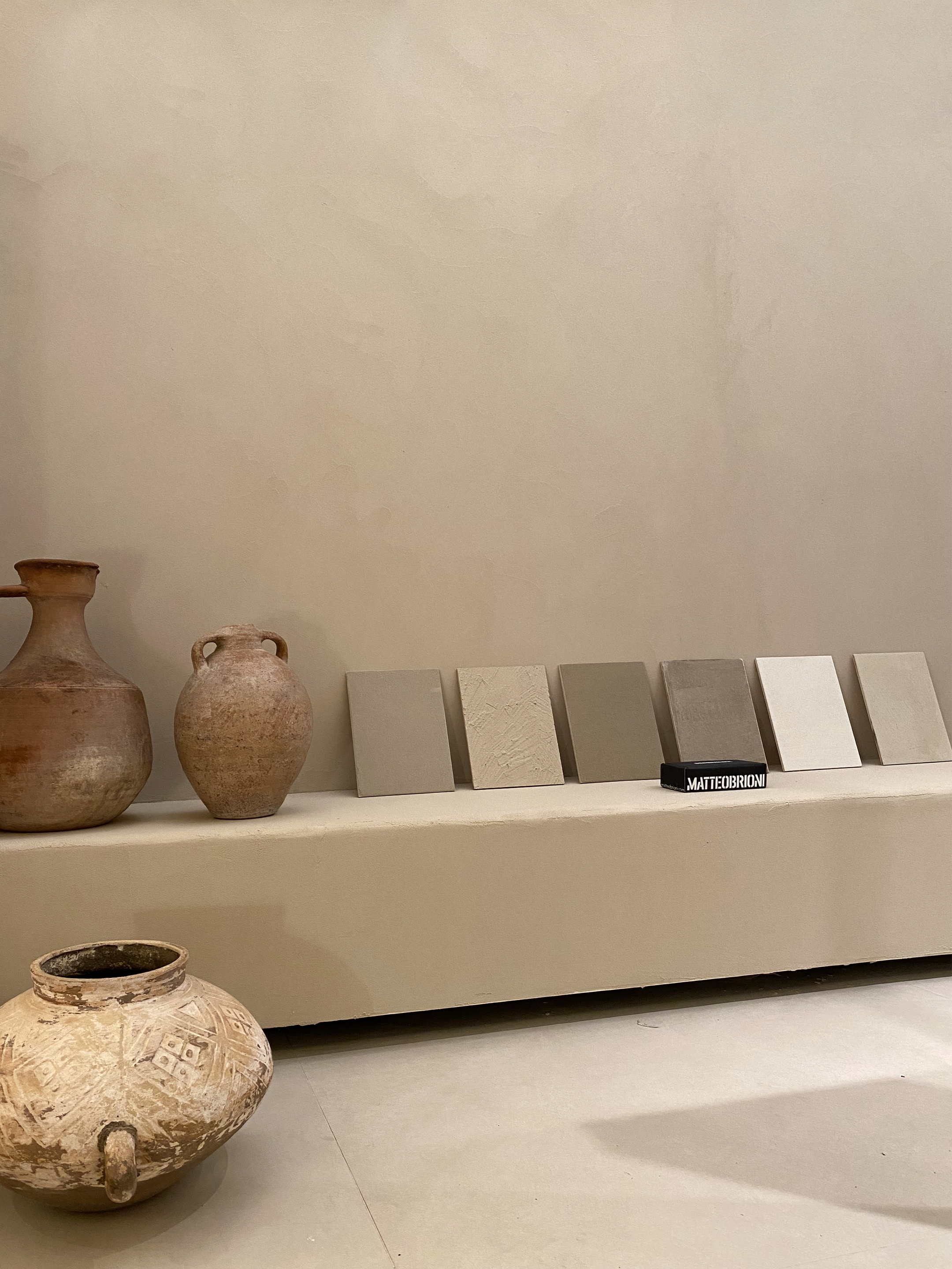 TerraVista Smooth fine-grained clay finishing plaster and TerraSilk Smooth clay paint both in Panna (cream) color applied to panels in the Mediterranean spa stand at the Marbella Design &#038; Art fair. Project by Nina Dubarry