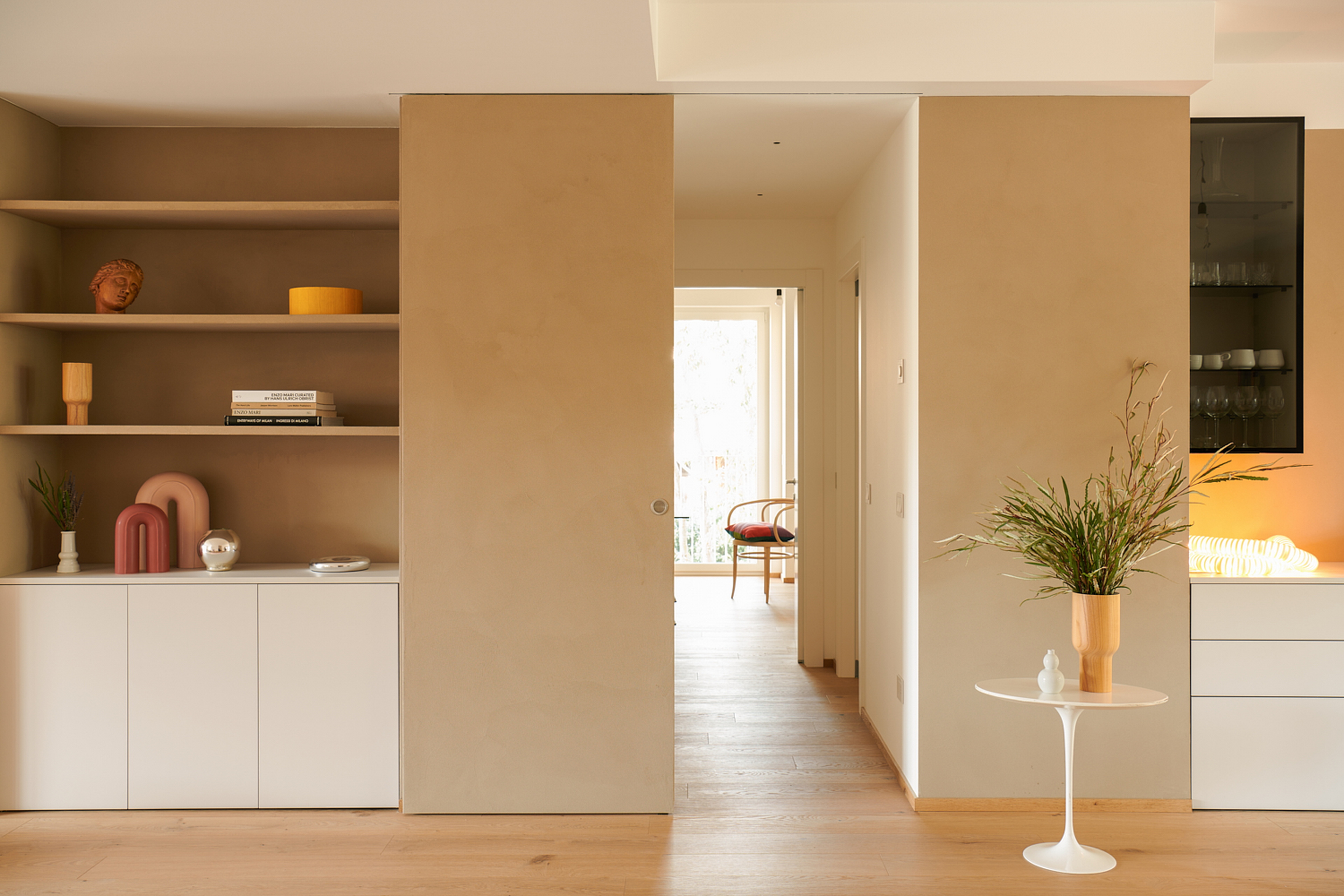 TerraVista Smooth Cannella (cinnamon color) fine-grained clay finishing plaster applied to shelves, containers and sliding panels for an interior architecture in Milan by Studio Irvine. Photography by Natalia Garcia