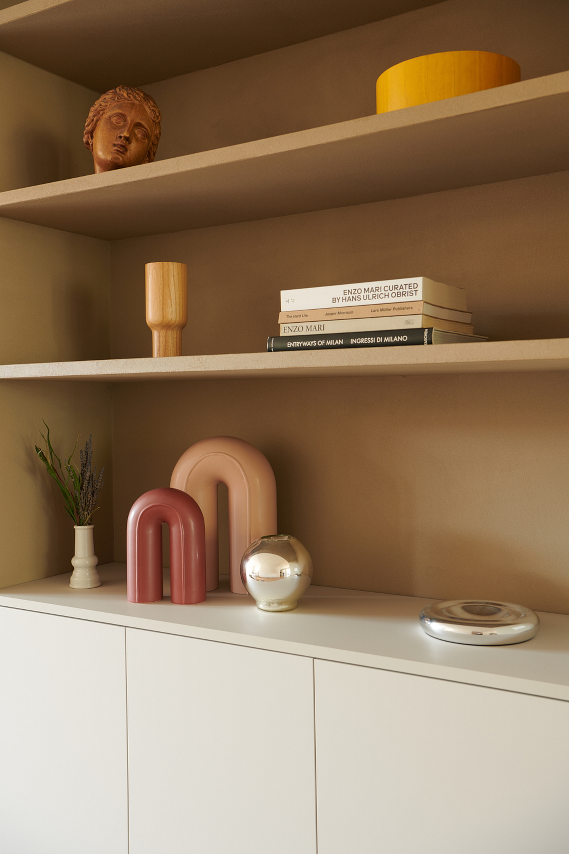TerraVista Smooth Cannella (cinnamon color) fine-grained clay finishing plaster applied to shelves, containers and sliding panels for an interior architecture in Milan by Studio Irvine. Photography by Natalia Garcia
