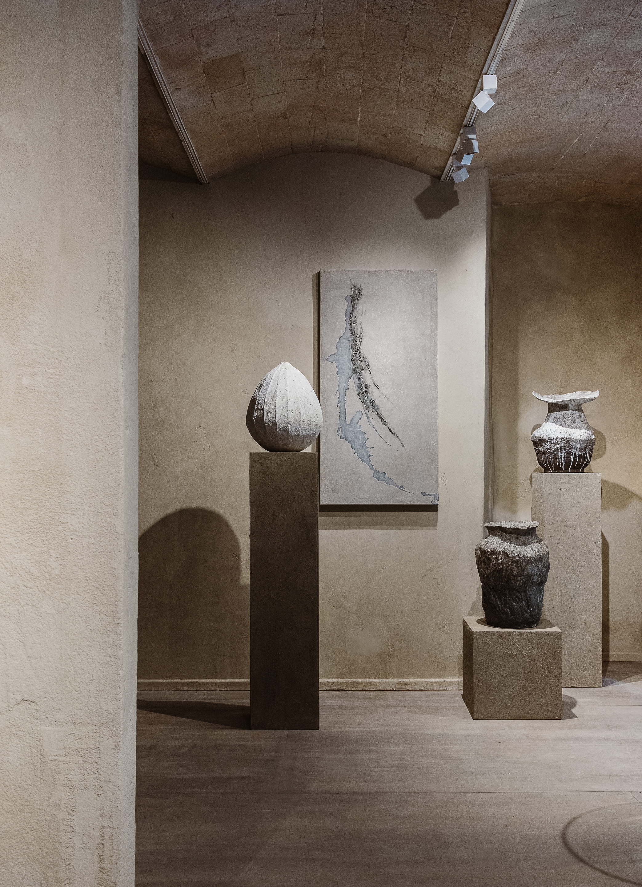 Intonaco di finitura in argilla a grana fine TerraVista Liscio Panna e intonaco in terra cruda a grana grossa MultiTerra Wabi Polvere e Sale Grigio applicati sulle pareti della galleria Kalpa Art Living nel palazzo Bonomini a Volterra. Progetto di Olga Niescier, foto di Simone Stanislai su gentile concessione di Kalpa