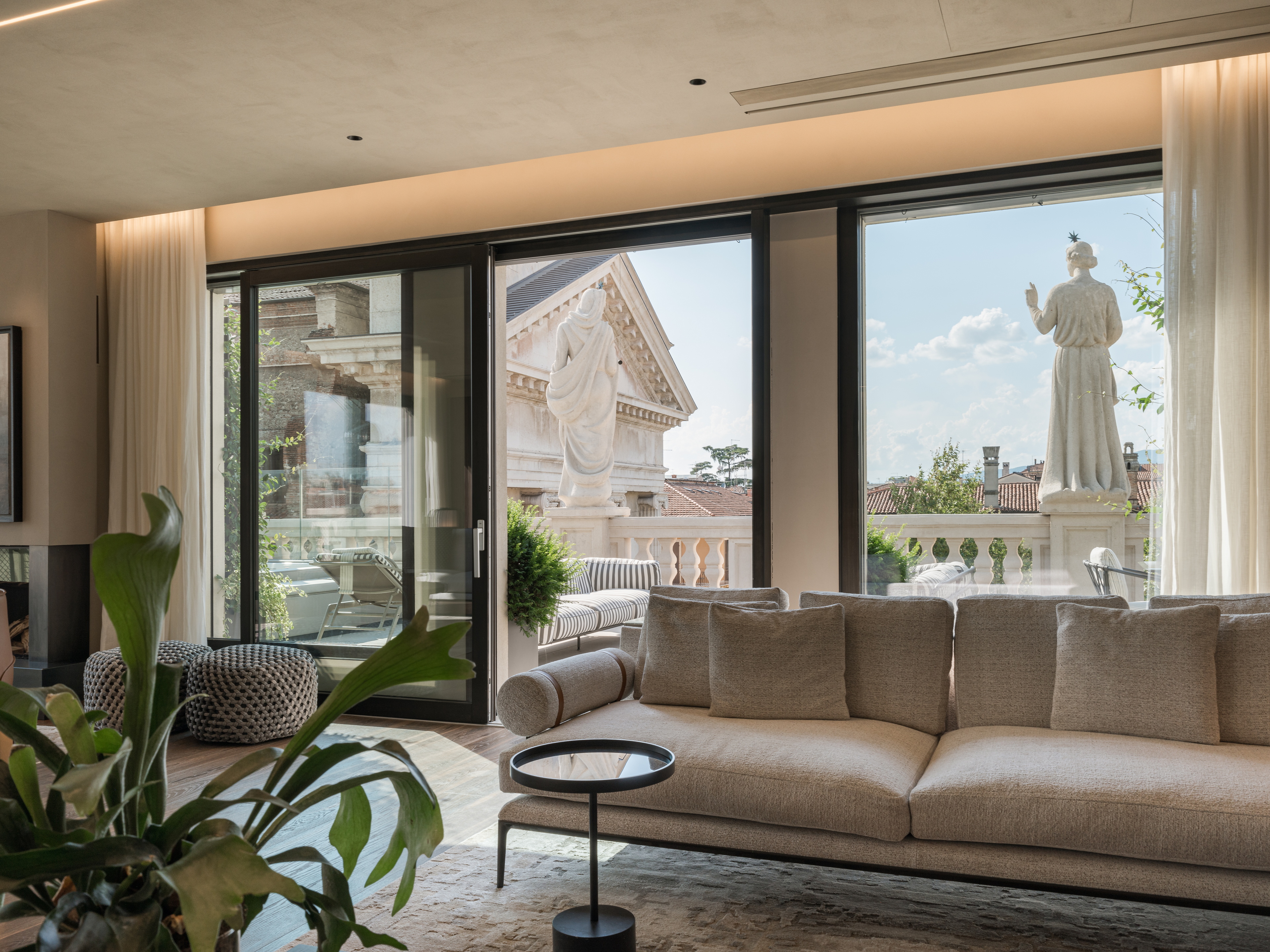 Clay finishes for a penthouse in the centre of Verona. The ceilings are adorned with natural clay paint TerraSilk Structured in Sale Grigio (grey salt) color, and the walls are finished with fine-grained clay finishing plaster TerraVista Smooth in a custom color. Project by Emanuele Soldi Architetto Photography: Michele Mascalzoni